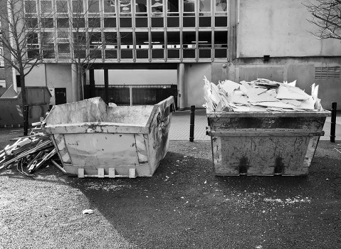 Construction site with waste being cleared by professionals